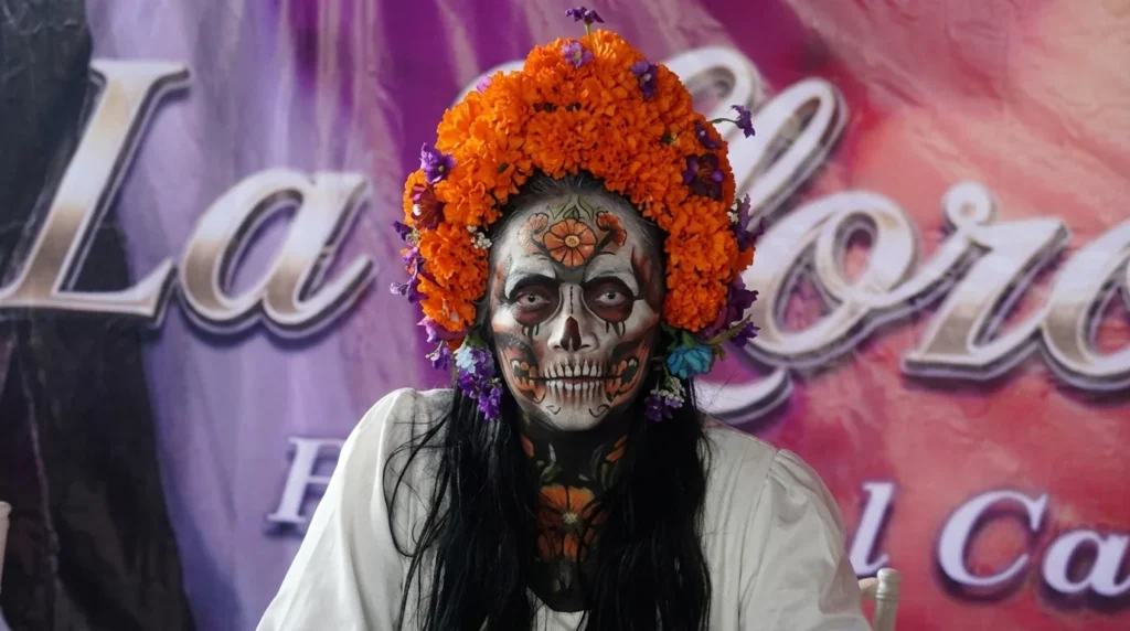 La Llorona Xochimilco durante la presentación de Al Final del Camino en Cuemanco, rodeada de elementos inspirados en la tradición chinampera.
